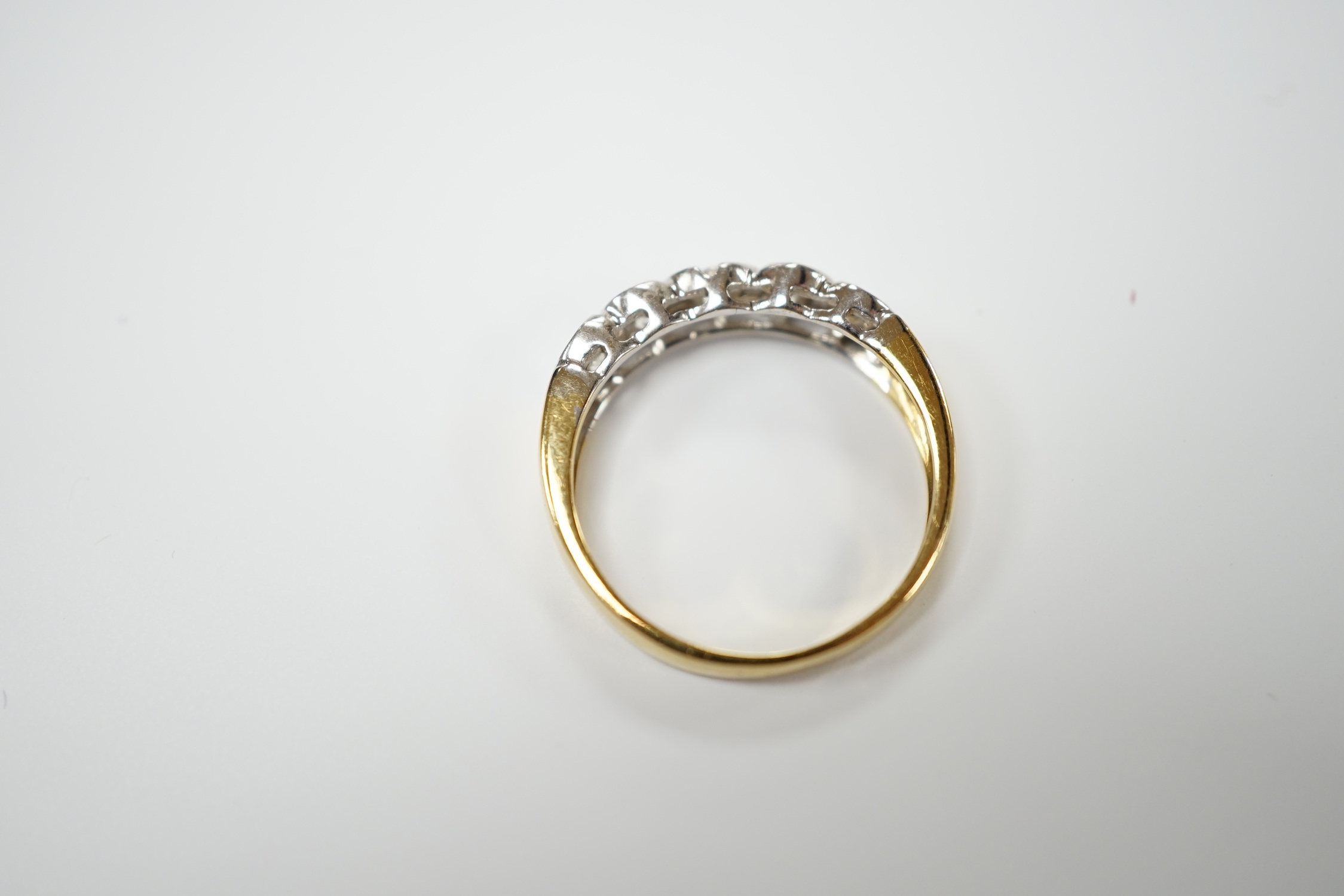 A modern 18ct gold and collet set five stone diamond half hoop ring, size O, gross weight 3.5 grams.